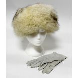 A white Fox fur hat with a pale grey knitted crown and a pair of kid leather grey gloves (1980s)