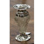 A moulded and cut glass vase on silver pedestal, with flared silver rim,