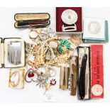 A bag of costume jewellery including a triple string of faux pearls, Ronson cigarette lighter,