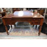 A Victorian mahogany writing desk, four small drawers,