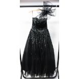 A black sequinned YVE of London strapless design with a very full skirt,