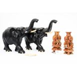 A pair of carved ebony and bone elephants and a pair of soapstone carved vases (4)