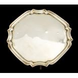 A George V silver salver, octagonal form with ogee fluted border, on four scroll feet,