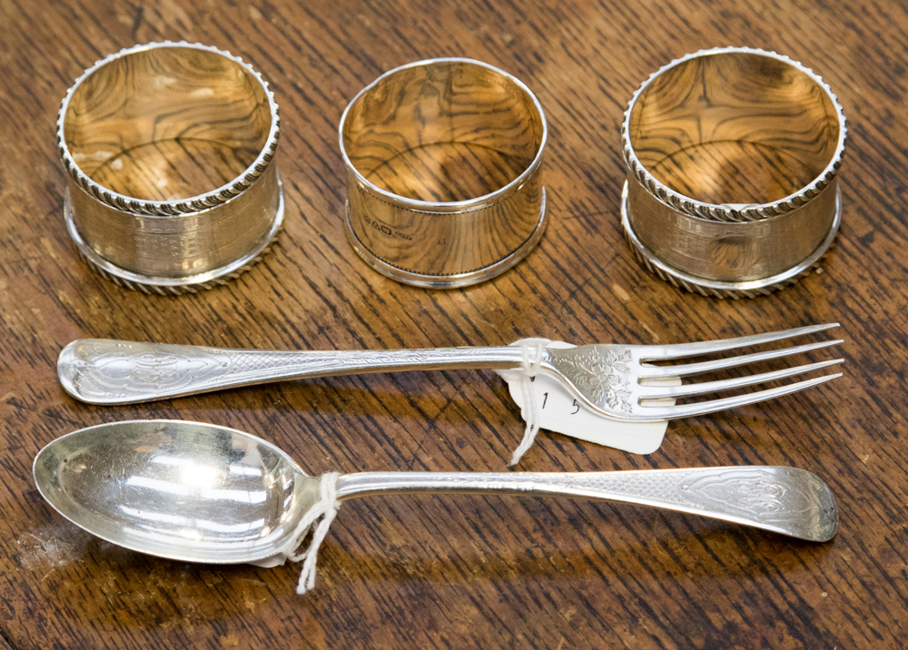 Three silver napkin rings and a Christening set, comprising spoon and fork,