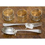 Three silver napkin rings and a Christening set, comprising spoon and fork,