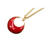 Lanvin of Paris, a 1970s Lucite and gilt metal pendant on chain, red convex crescent form,