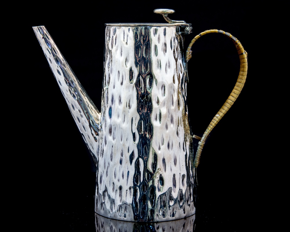 Attributed to Christopher Dresser for Hukin and Heath, a silver plated coffee pot, planished,