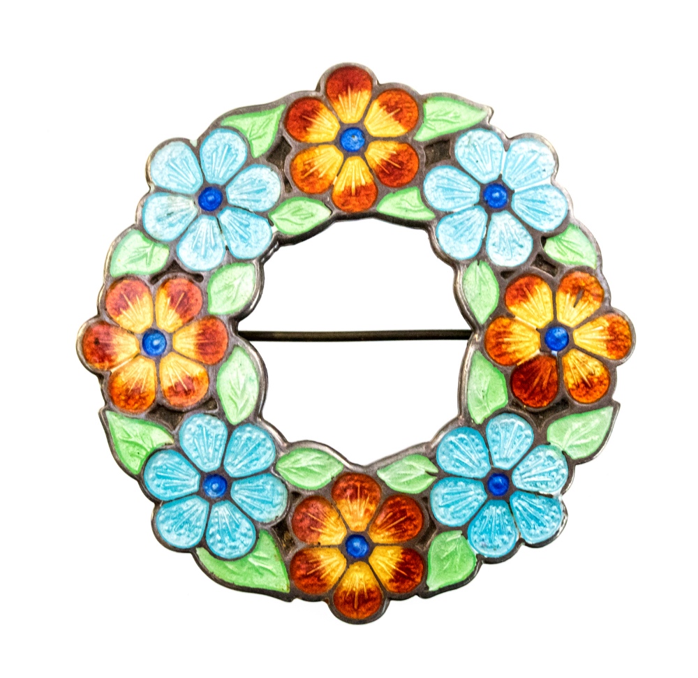 A 1940s enamelled silver wreath brooch, periwinkle and petunia within leaves, circular design,