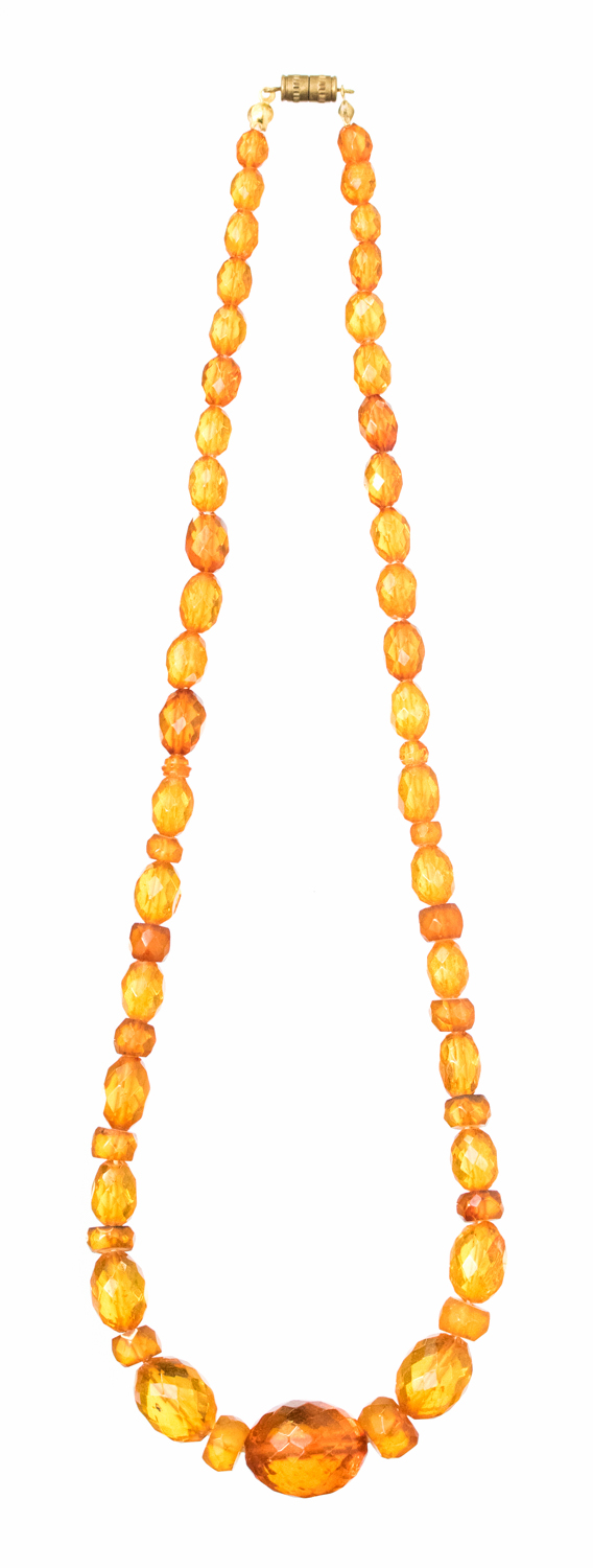 A 1920s amber bead necklace, graduated facet cut, clear, lozenge and disk beads 53.5cm long, 23.