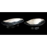 A pair of Modernist silver dishes, hand hammered oval boat bowls on plain cylindrical feet, ELK,