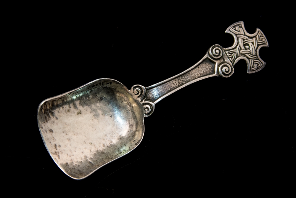 A Scottish Arts and Crafts silver caddy spoon, Iona style, the handle in the form of a Celtic cross,