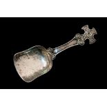 A Scottish Arts and Crafts silver caddy spoon, Iona style, the handle in the form of a Celtic cross,