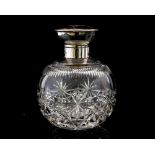 An Edwardian cut glass, tortoiseshell and silver mounted perfume bottle,