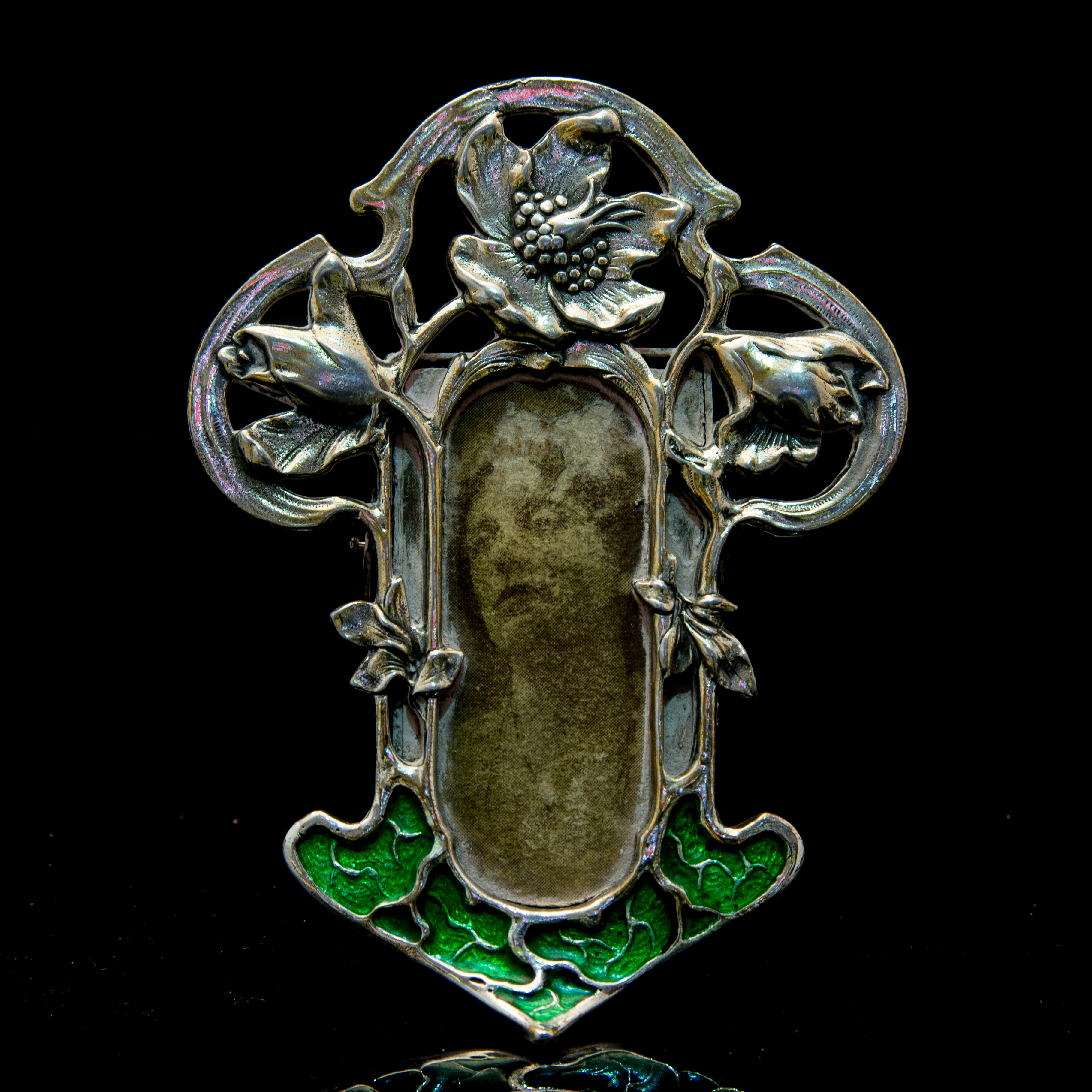 An Art Nouveau style white metal and enamelled photograph frame,