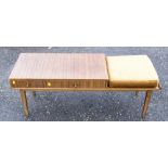 A 1950s teak telephone table, angular form with square tapered legs and brass feet, 122cm wide,