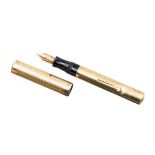 An 18 carat gold Swan self filling fountain pen, engine turned body and cap, lever filler,