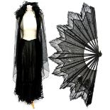 A Victorian black chiffon fan edged in fine lace edging and decorated with silver stars (some