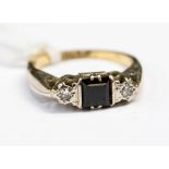 A sapphire and diamond 18ct yellow gold and platinum set ring, the square step cut sapphire,