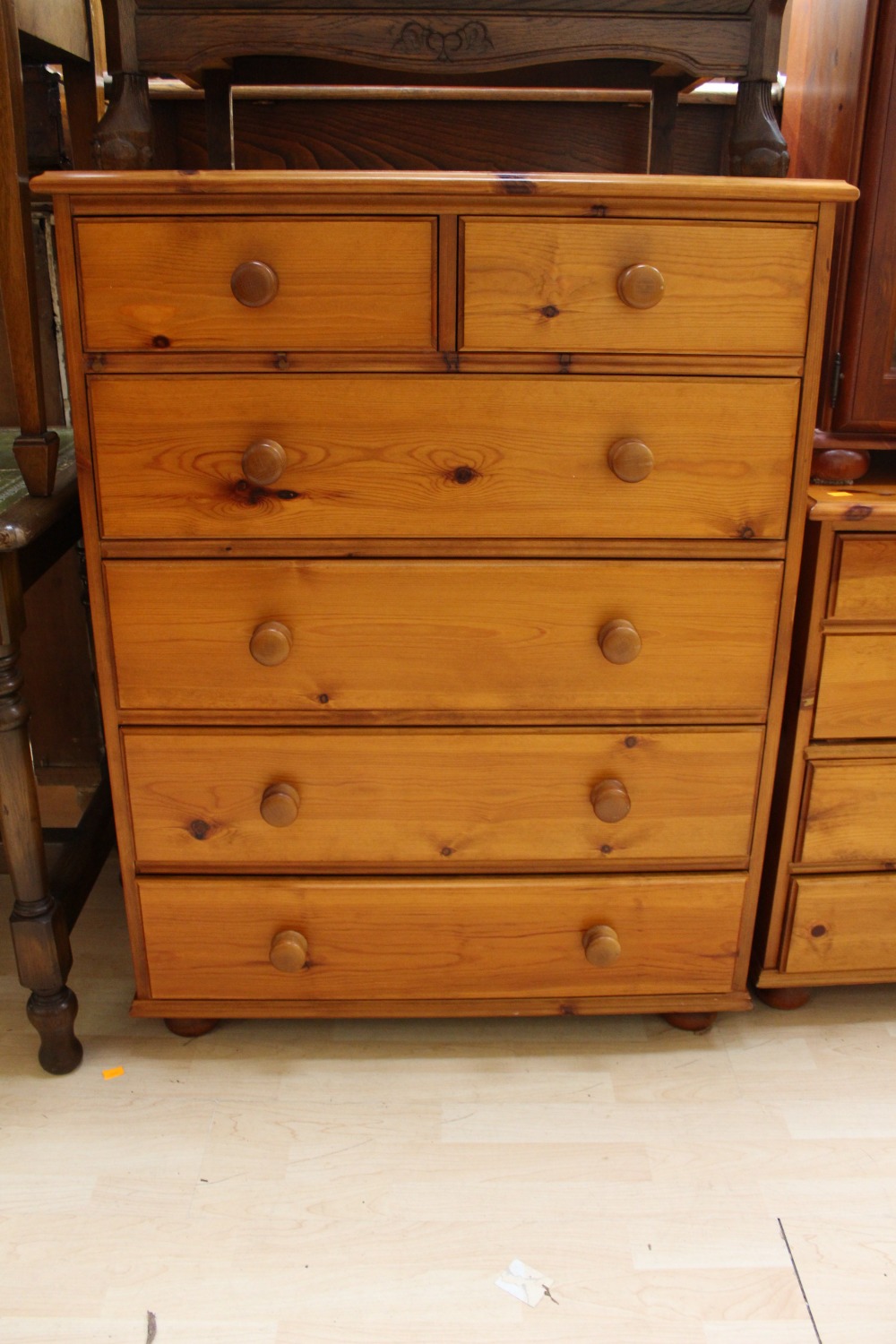 A contemporary pine chest of drawers fitted with two short over four long graduated drawers