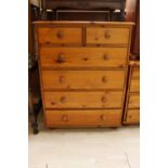 A contemporary pine chest of drawers fitted with two short over four long graduated drawers