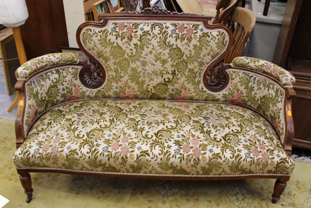 A late Victoria mahogany settee, upholstered back and seat, pierced and carved sections to back,