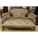 A late Victoria mahogany settee, upholstered back and seat, pierced and carved sections to back,