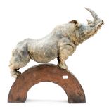 A modernist sculpture of a Rhinoceros on an arched stand