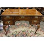A George II style walnut desk, fitted with five drawers, standing on cabriole legs, 79cm high,