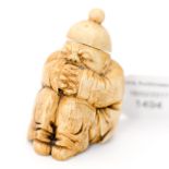A Chinese carved ivory snuff bottle, in the form of a squatting mandarin,