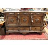 A 17th Century style oak sideboard, fitted with three doors over three drawers, 88cm high,