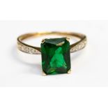 A yellow metal ring set with green stone, ring size Q 1/2, total gross weight approximately 2.