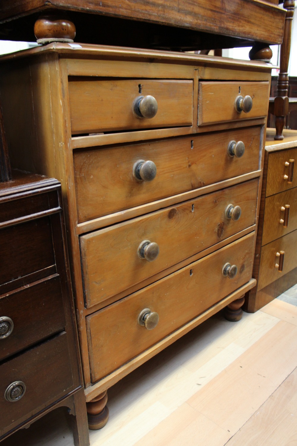 A Victorian pine chest of drawers, fitted with two short over three long graduated drawers,