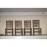 A set of four ash wavy ladder back chairs, with rush seats,