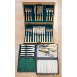 A boxed set of mother of pearl tea knives, boxed fish eaters and a small canteen of cutlery,