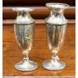 A pair of Edwardian silver baluster vases, Joseph Gloster Ltd, Birmingham, 1911 and 1912 (af),