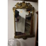 A Rococo style gilt framed wall mirror, 96cm high,