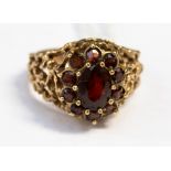 A garnet cluster rose metal ring, textured driftwood style shank, size N 1/2,