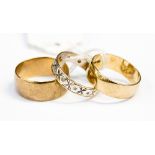 Two 9ct gold wedding bands and a 9ct gold and diamond chip set eternity ring, ring sizes Q and S,