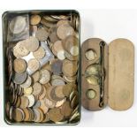 A tin of coins with a boxed Guinea balance