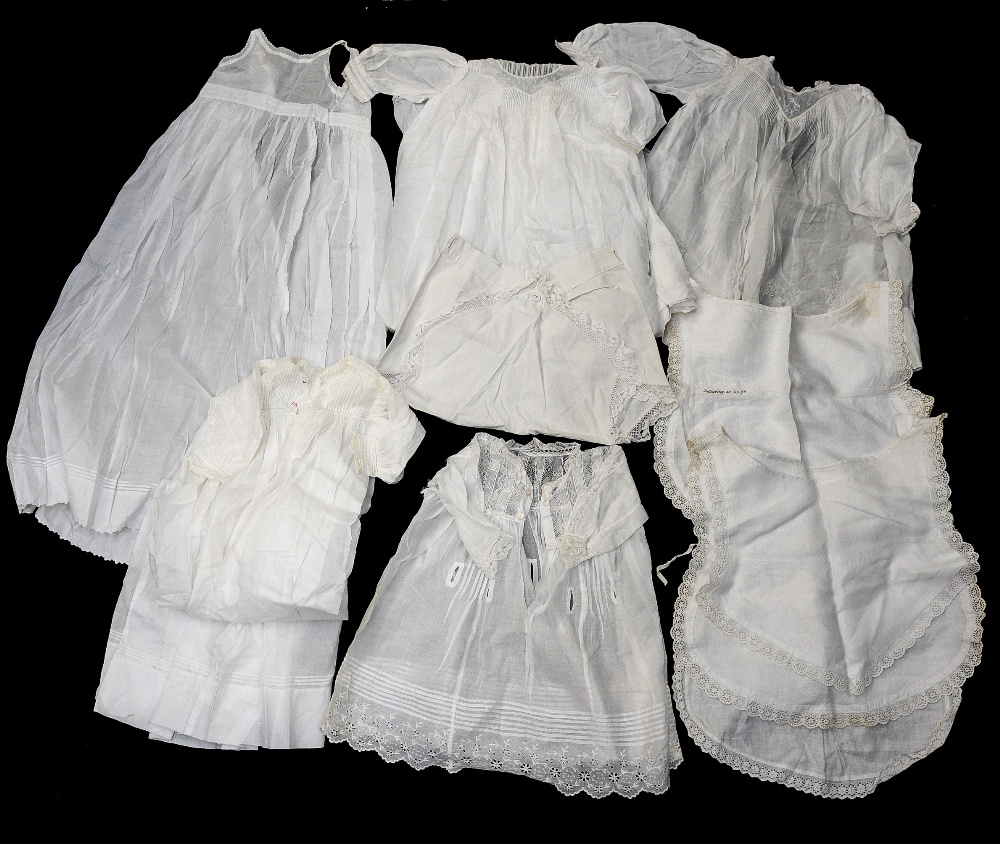 A collection of Christening robes, nightdress's, cotton bibs and over smocks,
