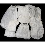 A collection of Christening robes, nightdress's, cotton bibs and over smocks,