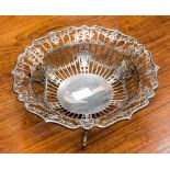 A silver pierced fruit bowl, standing on three scroll feet, hallmark Sheffield 1913,