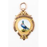Pigeon Medal: A 9ct gold pigeon medal with enamelling to front of a pigeon,