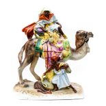 A large Victorian Royal Dux figural group, of a camel, rider and attendant, painted in gloss finish,