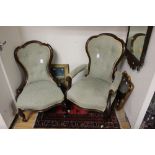 A Victorian gentleman's armchair, together with a matching ladies chair,