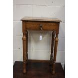 A traditionally made oak side table, fitted with a single drawer and standing on turned legs,