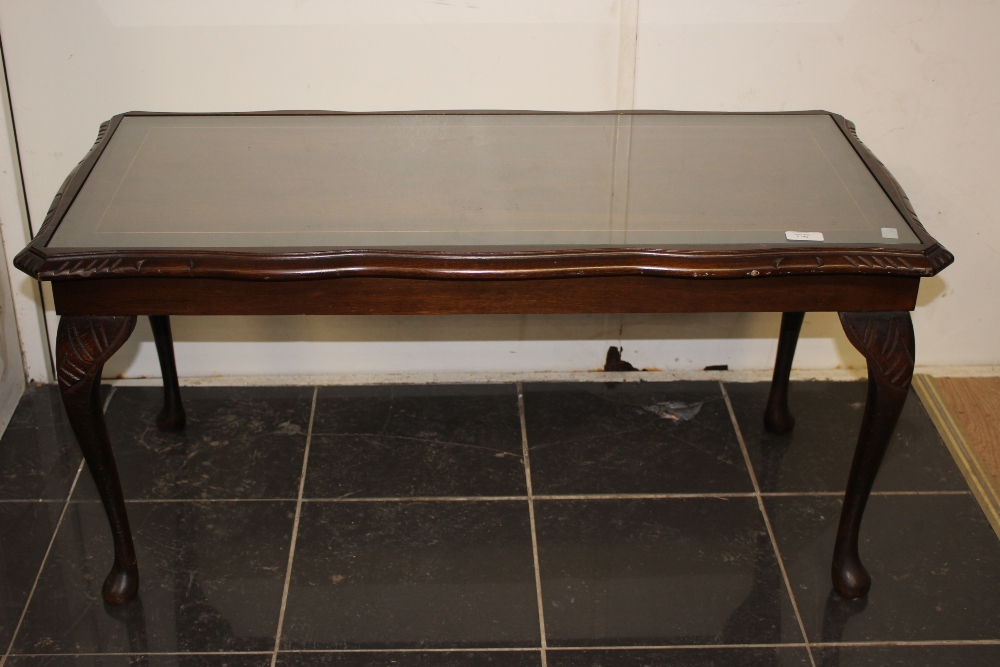 A Regency style 1970's coffee table with glass top