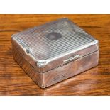 A silver cigarette box, engine turned stripes,