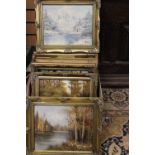 A box containing a collection of six various oil paintings, mostly depicting rural landscapes,