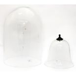 A glass dome measuring approx 51 cm high (20 inches) with a contemporary glass dome (cloche) (2)